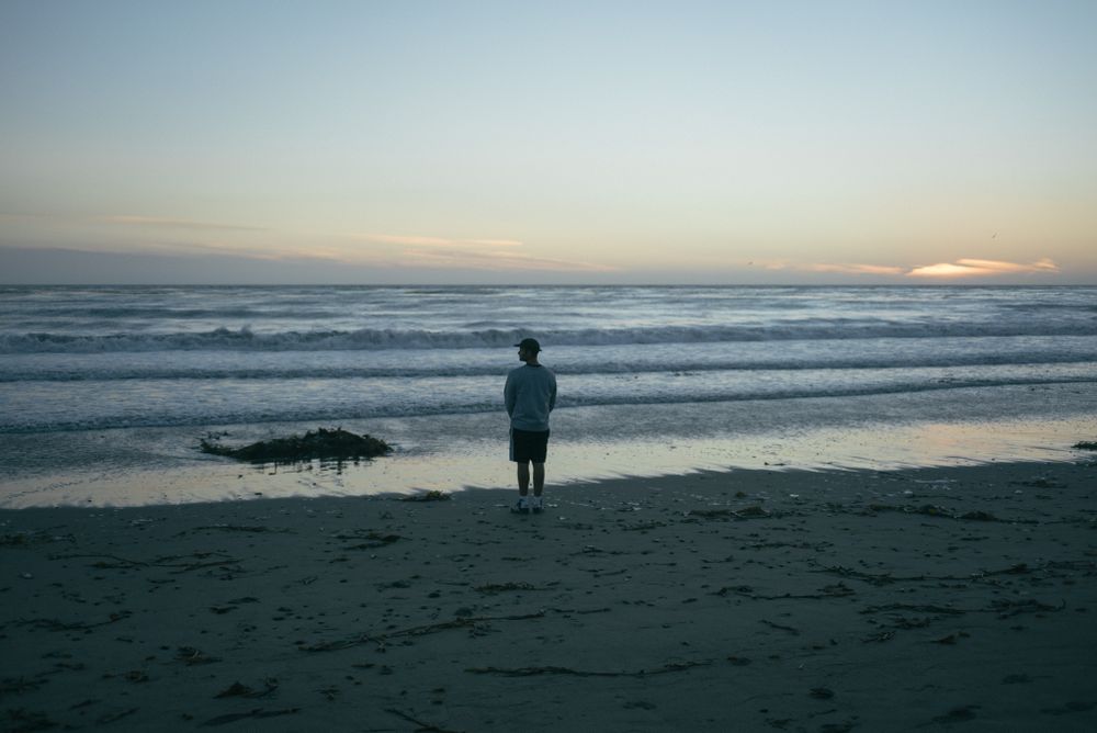 Back of man looking to the side on beach in California