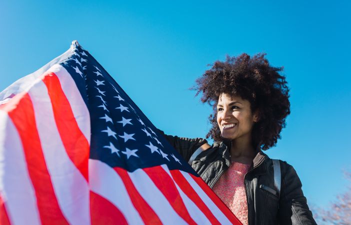 Black woman with afro hair and an american flag