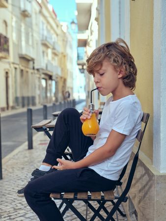 Boy drinking juice on street