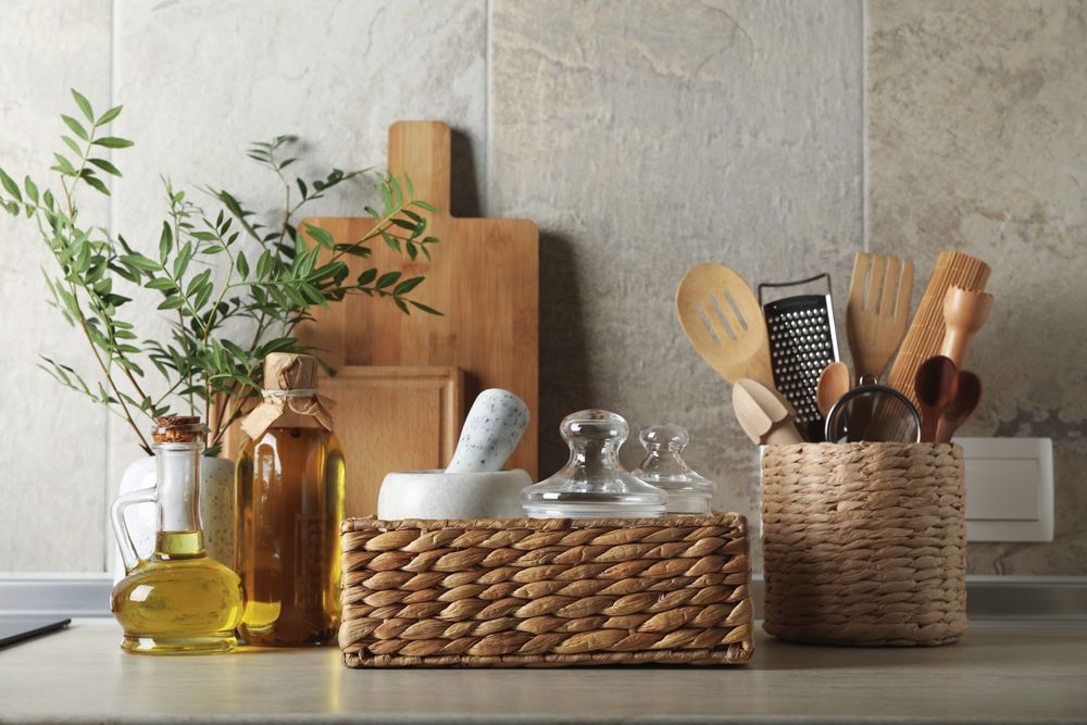 Kitchen table with different supplies and vase with plant
