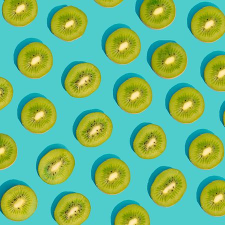 Fresh green kiwi pattern on a blue background