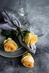 Floral card with yellow flowers scattered on grey table setting
