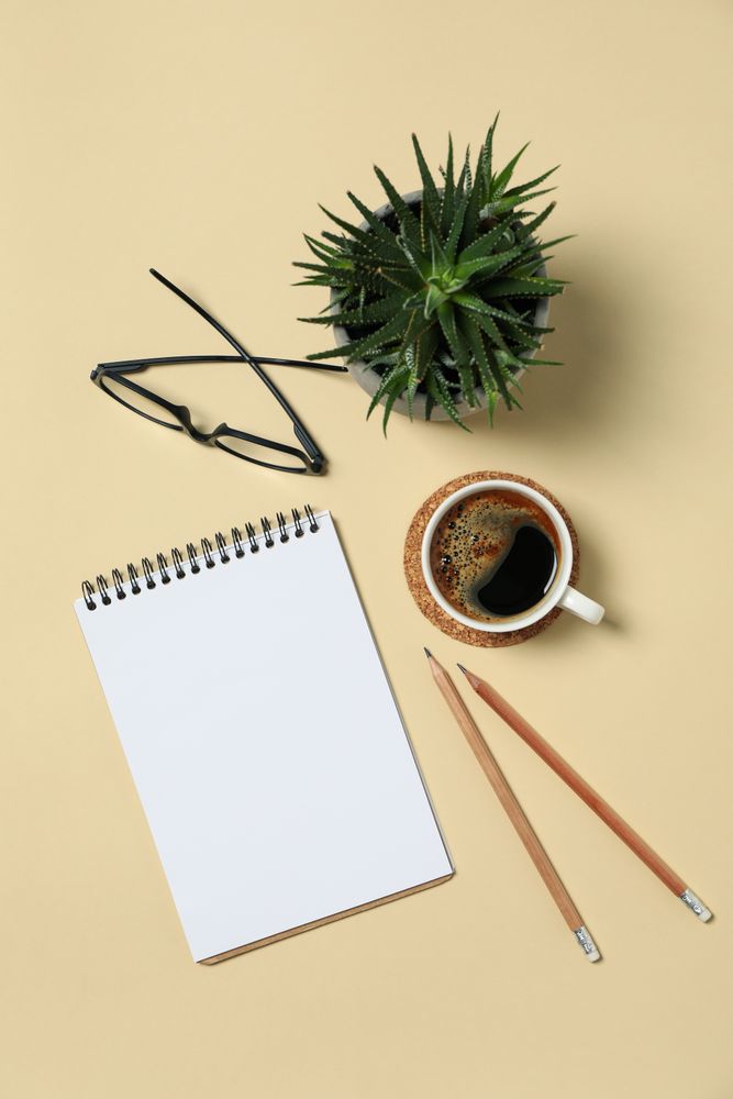 Office concept with blank notebook on beige background, space for text
