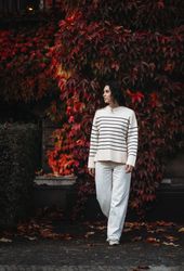 Fashion woman on a background of red and yellow autumn leaves