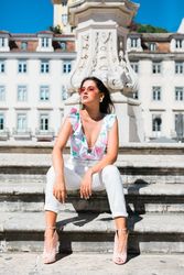 stylish woman in sunglasses sitting in street stairs