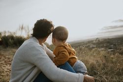 Mother and son sitting outside on an overcast day