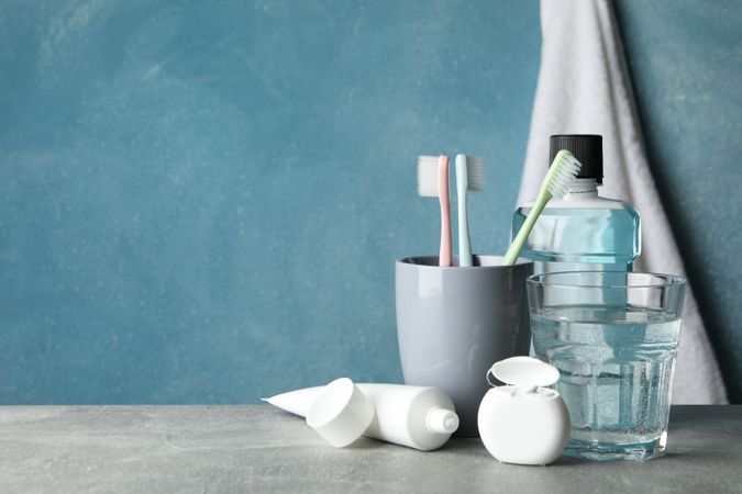 Tools for dental care on blue background, space for text