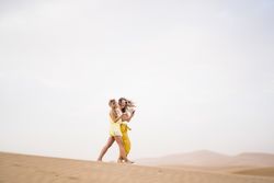 Happy women walking in the desert in desert