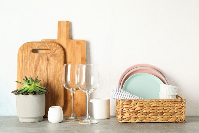 Set of dinnerware with succulent plant on grey table, space for text