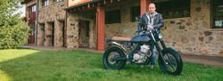 Man posing with a custom motorbike