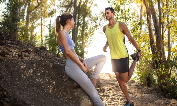 Couple taking break after mountain trail running workout