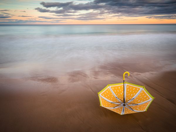 Umbrella on beach near sea
