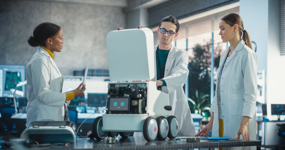 Young Male and Female Engineers in a Lab Discussing an Automated AI Robotic Delivery Assistant, Brainstorming Improvement Ideas