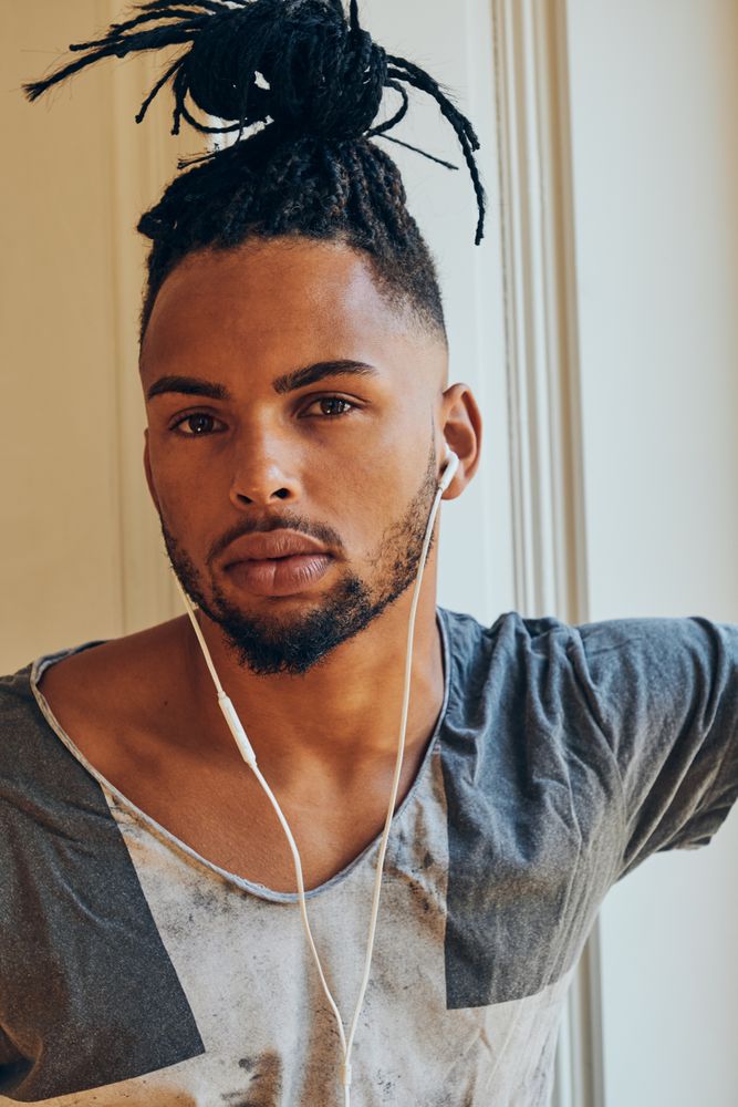 Black man looking out window