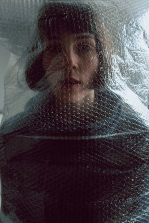 Woman entangled in bubble wrap