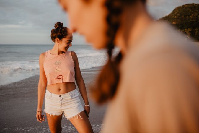 Smiling women looking away on beach