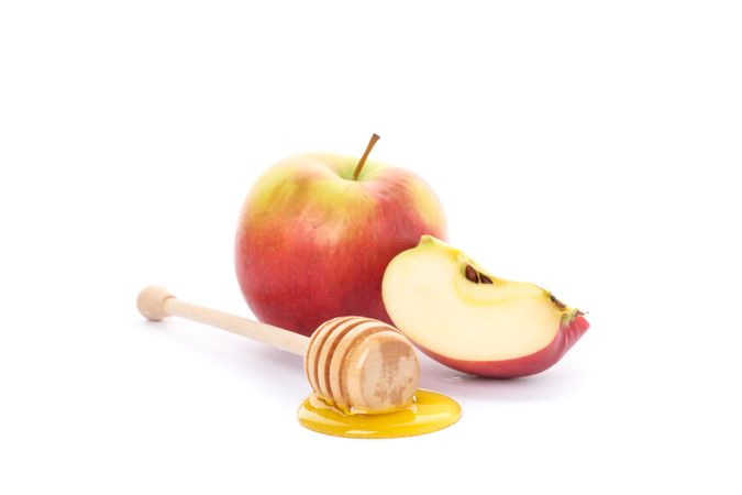Apple and dipper with honey isolated on neutral background