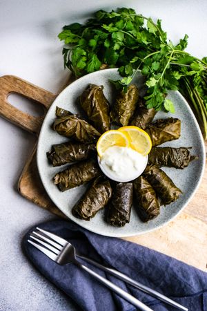 Top view of traditional Georgian stuffed grape leaves served with knife and fork