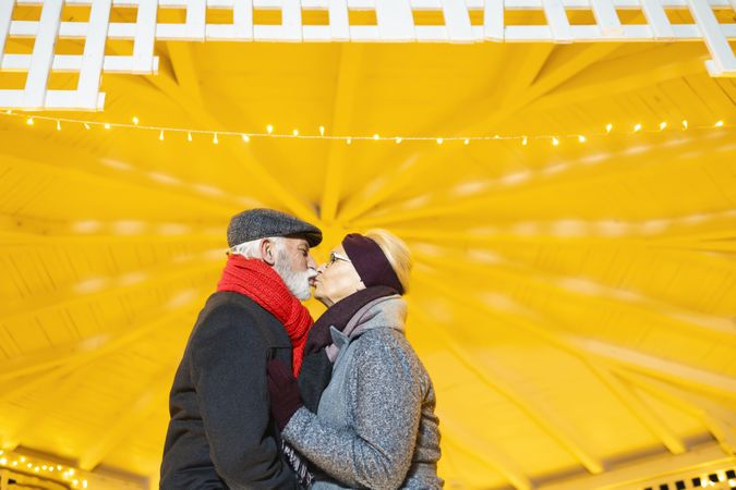 Older couple kissing under a gazebo
