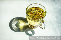 Freshly poured herbal tea in glass mug bGRNNX