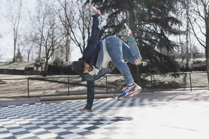 Man dancing break dance in park