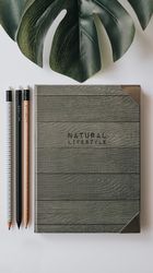Writing accessories on table and near of palm leaf