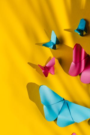 Paper butterflies on yellow cardboard