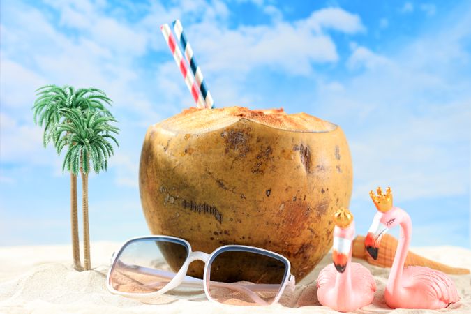 Young Coconut with Miniature on Beach Concept
