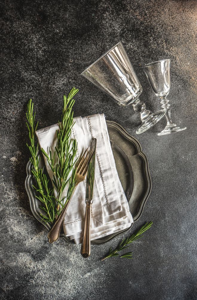 Table setting with fresh rosemary and glassware