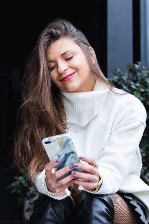 Content woman using smartphone in park