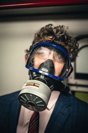 Man in suit and gas mask