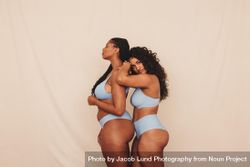 Confident best friends modeling together in studio showing their natural curves 47Dpzb