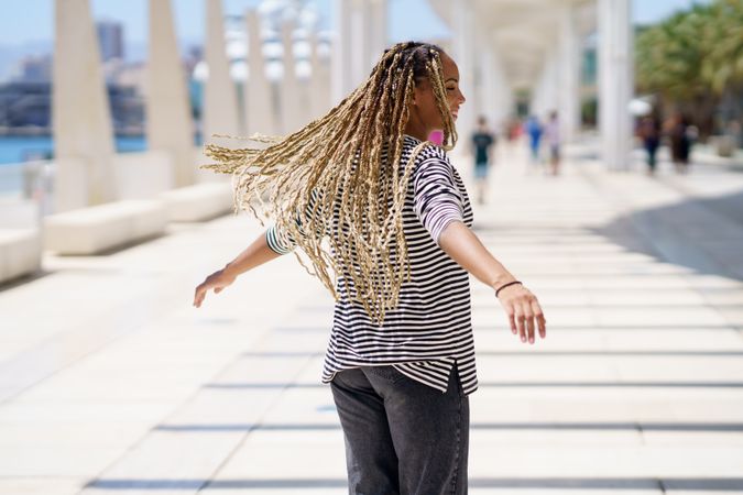 Carefree woman dancing in bright outdoor area