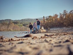 Teenagers activists seeking garbage and plastic waste in river s