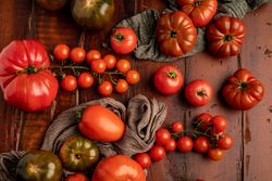 Tomatoes and napkins on wooden table