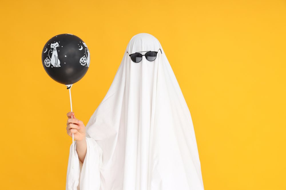 Concept of Halloween, Ghost with Halloween balloon on yellow background