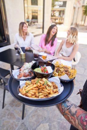 Waiter serving food for positive women on street