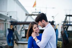 Loving couple embracing on urban pier with dock