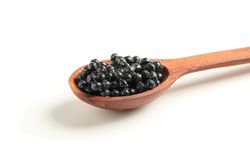 Spoon with caviar isolated on plain background, closeup