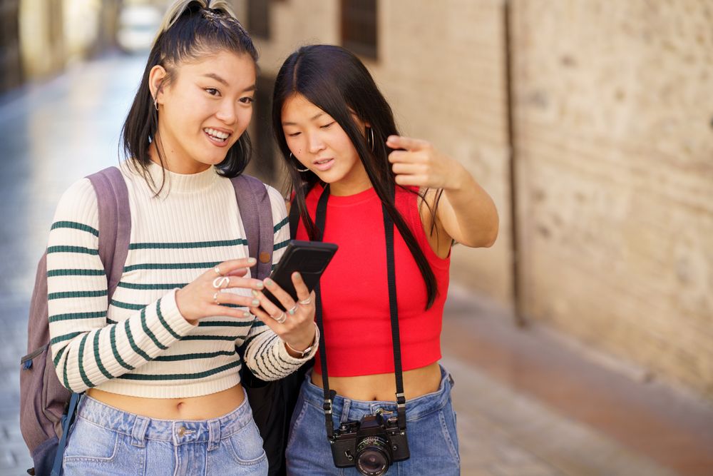 Two women using phone to get around a Spanish town