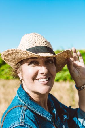 Female farmer with hat looking at camera