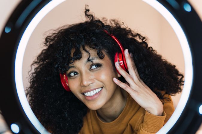 Smiling Black woman listening to music in headphones
