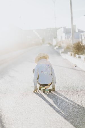 Stylish girl with skateboard on street