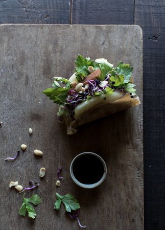 Served Gua Bao sandwich with sauce on board