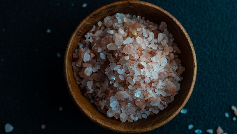Top view close up of pink salt in bowl