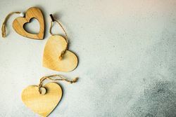 Valentine's day concept with three wooden heart decorations 