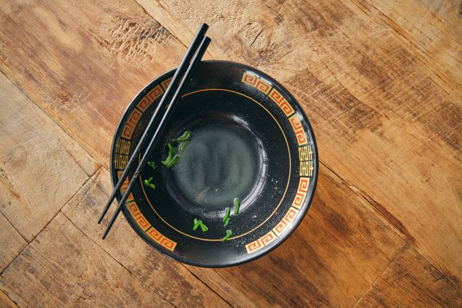 Ornamental bowl with chopsticks on wooden desk