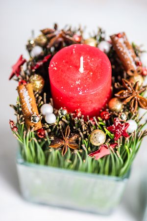 Top view of red Christmas candles and spice decor in vase