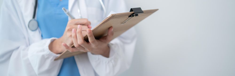 Doctor standing in bright hospital room with copy space, banner
