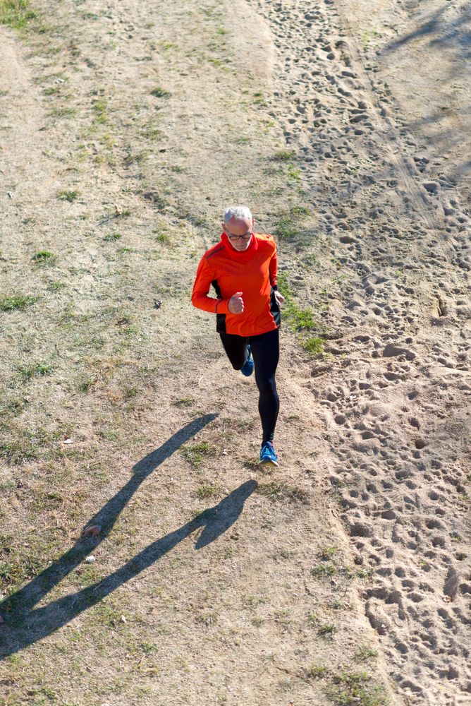 Looking down at older male working out in park